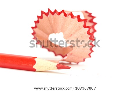 red pencil and sharpener with a shaving