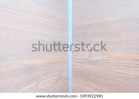 Two parts of the bathroom wall Made form synthetic wood.
