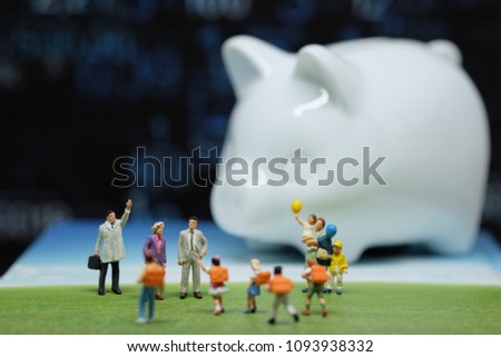 Miniature people : Happy family and children standing on green floor with piggy bank and  coines backgroung. Picture use for keep money for the future ,education and life insurance concept.