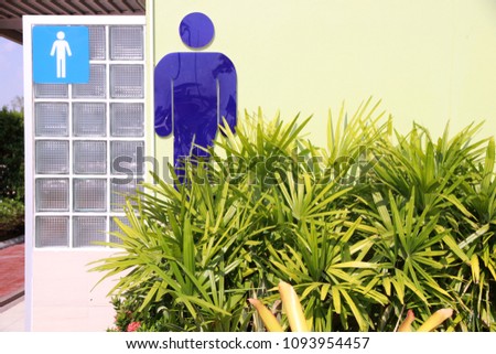 men toilet sign and green garden