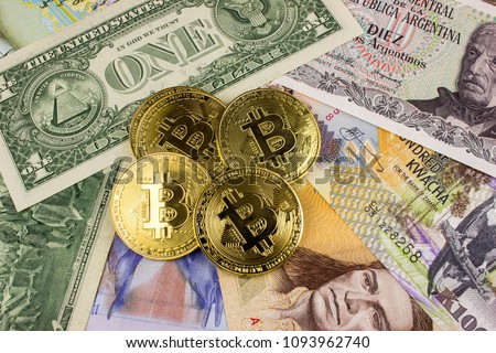 Golden Bitcoins on a set of multinational bank bills. The currency of future.  