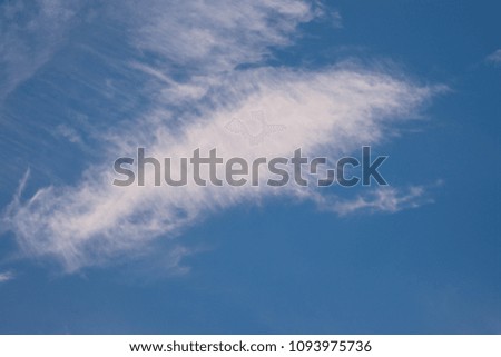 Fluffy clouds in blue sky.
