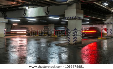 motion of cars at entrance and exit in underground shopping mall parking