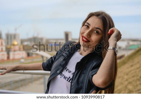 Fashionable beautiful woman in a black jacket on a summer day against the background of the city Royalty-Free Stock Photo #1093990817