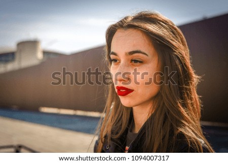 portrait of a beautiful girl in a summer day sitting on a park bench Royalty-Free Stock Photo #1094007317