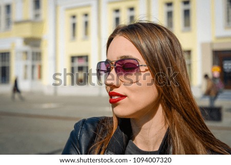 portrait of a beautiful girl in sunny glasses on a summer day sitting on a park bench Royalty-Free Stock Photo #1094007320