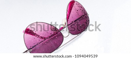 rose-colored glasses on white background