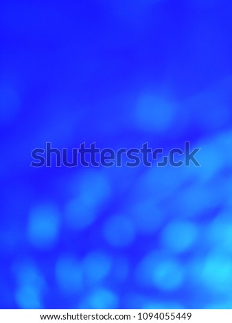 Abstract background of Blue and White color with bokeh defocused lights. Image is good to use as an Light Overlay. 