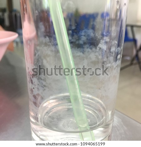 A glass of dirty water in a restaurant.