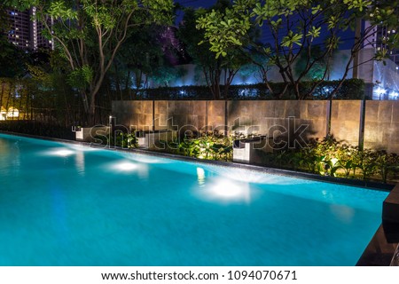 Pool lighting in backyard at night for family lifestyle and living area.  Luxury design with good light and clean landscaping.