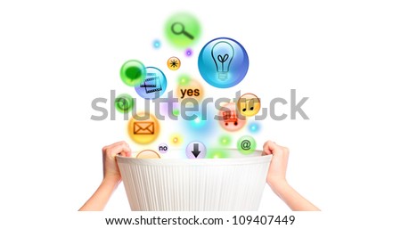 Humans hands holding a basket with lots of different icons falling inside. Web design service promotion