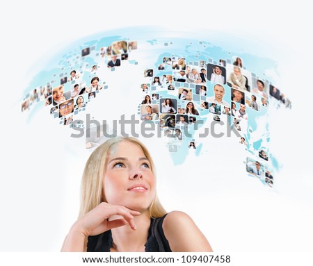 Young woman looking at virtual worldmap with photo of different people worldwide. International communication or online community concept.