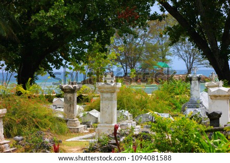 old cemetery and sea in background image, a view from la digue on the seychelles islands