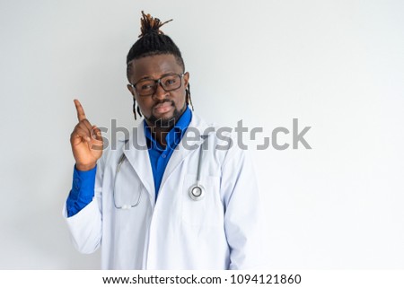 Confident creative black doctor with stethoscope having idea and holding index finger up. Pensive enterprising young African healthcare worker in glasses thinking of treatment. Solution concept