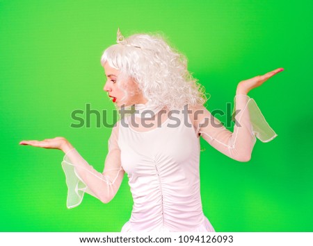 A picture of a pretty woman in a long curly veil and a diadem presenting your imaginary product over a colorful background