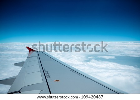 aircraft wing on the clouds,flying background Royalty-Free Stock Photo #109420487