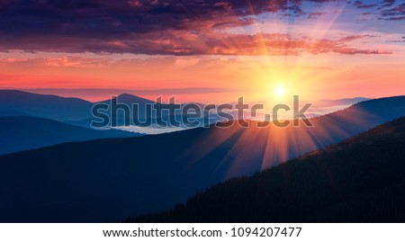 Panoramic view of colorful sunrise in mountains. Concept of the awakening wildlife, romance,emotional experience  in your soul, joy in mundane life.  Royalty-Free Stock Photo #1094207477