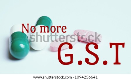 Business concept. Text 'No more GST' on pills and capsule background.