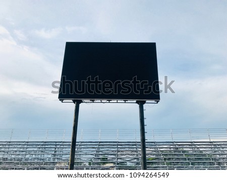 Black blank led billboard for outdoor advertising showcase in sport stadium with blue sky.