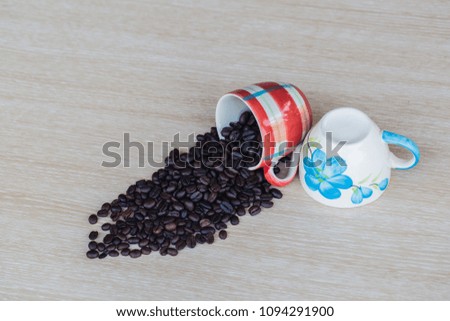 Coffee beans in coffee cup on wooden texture table