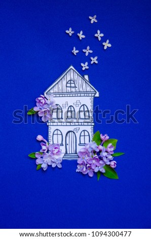 house of paper painted in lilac flowers and fresh flowers on blue paper background illustration, applique