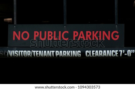 No public parking and clearance sign for a parking structure