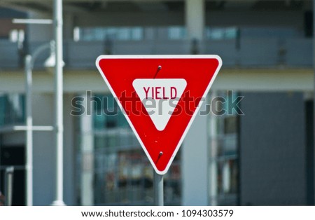 Yield sign with building in the background