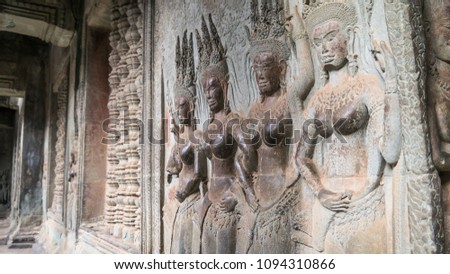 Beautiful carving Apsara dancer of Khmer culture in Angkor Wat, have been touched or rub by tourism and have deterioration.