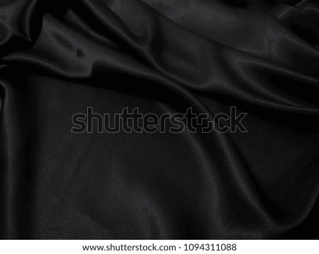 Black fabric texture background, wavy fabric slippery black color, luxury satin cloth texture.