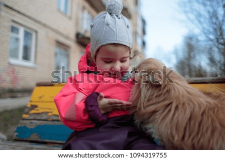 small and sweet girl with a fluffy dog
