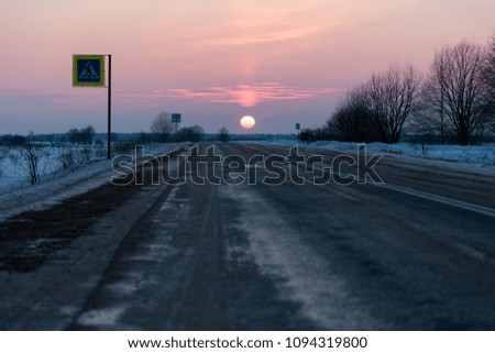 winter road against sunset background