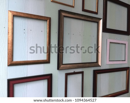 Picture frame on old wooden wall, vintage background.