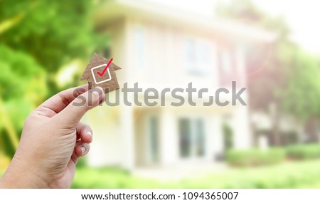 Hand holding brown paper , Home inspection  Royalty-Free Stock Photo #1094365007