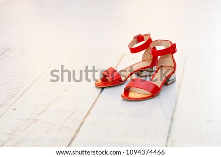 Red sandals on a low heel on the floor Royalty-Free Stock Photo #1094374466