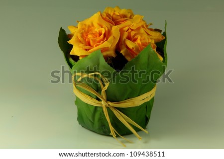 Fake yellow flower with green base