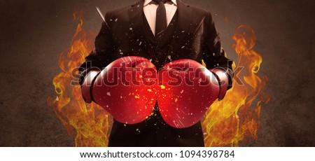 A strong sales person breaking something into pieces with red boxing gloves concept illustrated with glowing residue flying in the air.