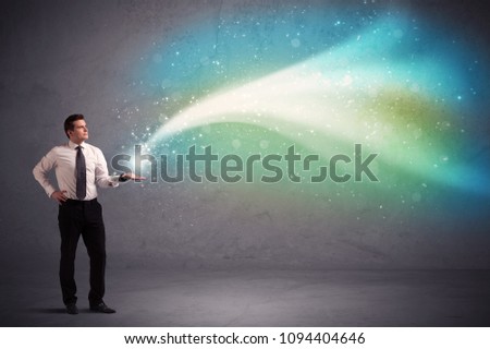 Caucasian businessman holding aurora borealis kind of stria of light