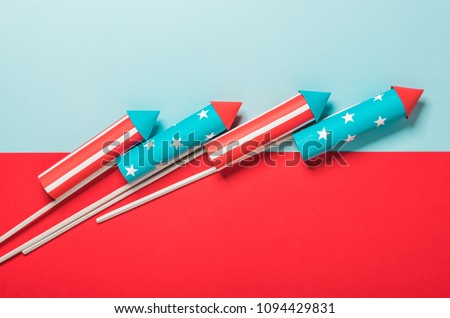 July 4, rockets for fireworks on a blue red background with space for text. in the style of minimalism