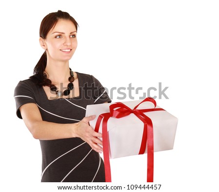 A smiling woman is holding a gift in her hand on white background