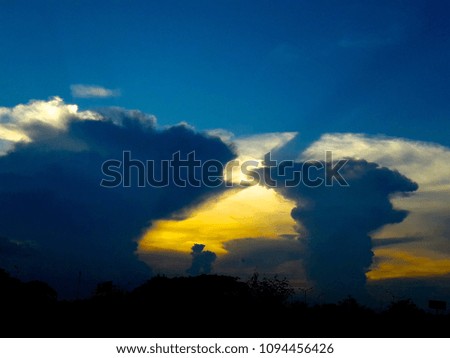 huge stormy dark clouds in evening sunsetting scene