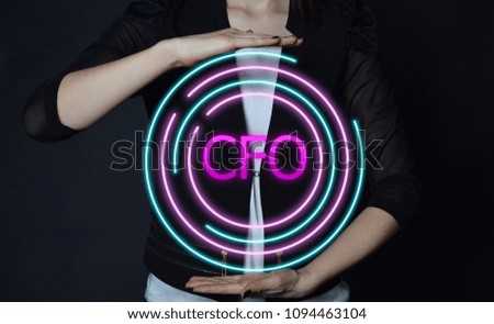 In the hands of a businessman, a neon circle with the inscription:CFO