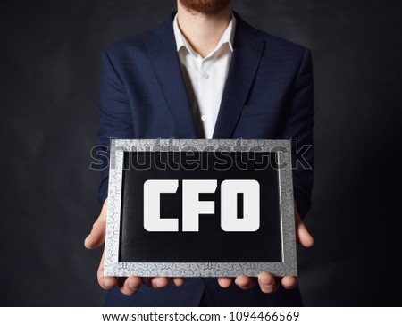 In the hands of a businessman a frame with the inscription:CFO
