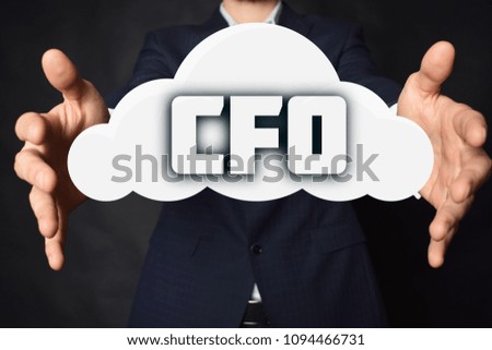 In the hands of a businessman, a cloud with the inscription:CFO