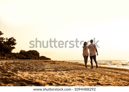 Two young lovers on beach and summer time. Mood photo style .