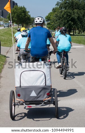 SON AND FATHER ON A BIKE WITH A BIKE TRAILER