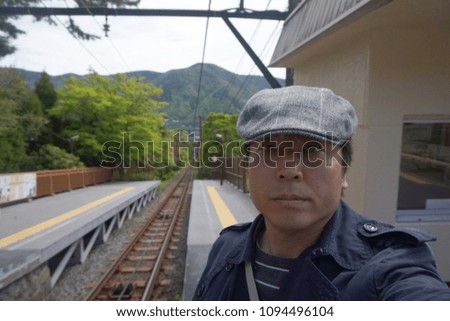 a man standing at hakone cable car railway in kanagawa, japan                       