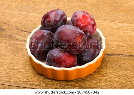 Ripe bright Plums in the bowl