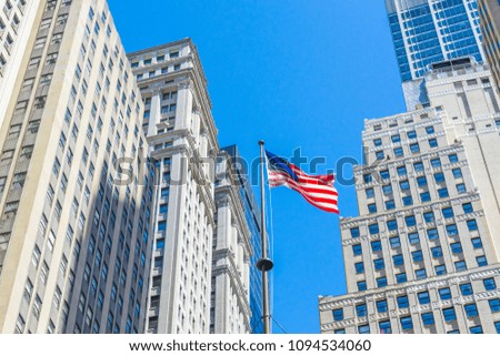 Flags of the United States with building in the background at Wall Street,NYC. 