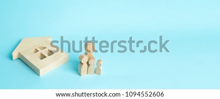 The family stands near the ruined fallen house. Loss of housing, home insurance. Accident, natural disaster, war. Buying immobility Homeless family. People stand near the house. banner