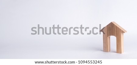 Wooden house with a large doorway on a white background. The concept of buying and selling real estate, rental housing. Affordable housing, investment and construction. banner.